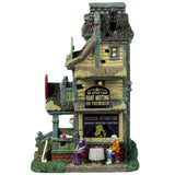 Porcelain lighted building for a Lemax display. Designed to look like light green three story building with moss growing on the roof. The top sign reads "OVER 200 CLIENTS! FROM GNOMES TO GIANTS!" The sign above the front door is shaped like a heart and reads "HAUNTED ATTRACTION. MONSTER MATCHMAKING AGENCY." There are two monsters on a date on the side of the building.