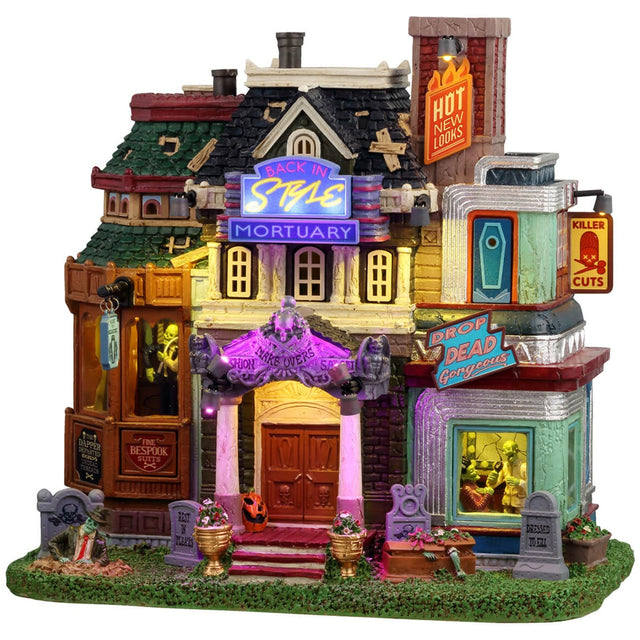 Resin lighted building for a Lemax display. Designed to look like a very colorful mortuary. There are tombstones in the front, and a zombie coming out of one of the graves. There are neon signs and inside the windows you can see zombie barbers.