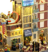 Resin lighted building for a Lemax display. Designed to look like a parking garage attached to a hotel. There's a pool on top of the garage with a monster's tentacle sticking out. The right side of the hotel is designed to look like an elevator. There's luggage all over the place.