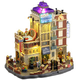 Resin lighted building for a Lemax display. Designed to look like a parking garage attached to a hotel. There's a pool on top of the garage with a monster's tentacle sticking out. The right side of the hotel is designed to look like an elevator. There's luggage all over the place.