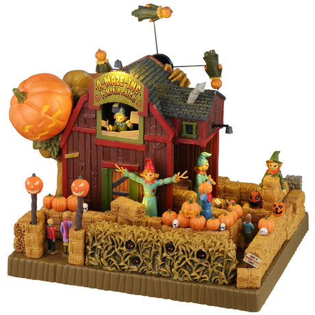 Resin lighted building for a Lemax display. Designed to look like a red barn with a pumpkin patch in front of it. There are scarecrows and jack-o-lanterns. There are weird pumpkin monsters flying above the barn. There are red glowing eyes inside the bales of hay.