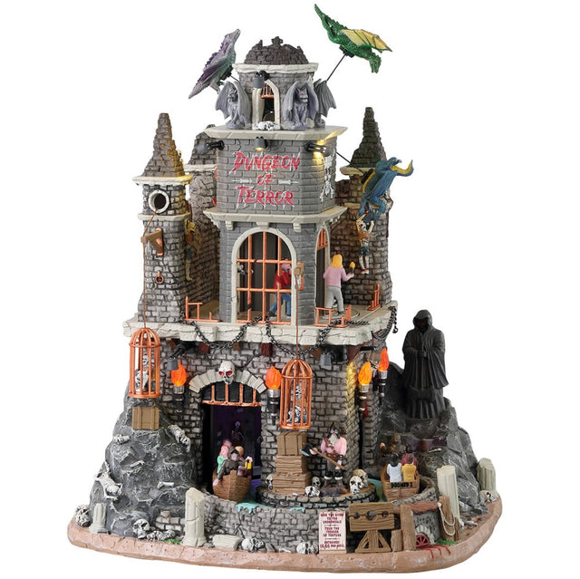 Resin lighted building for a Spooky Town display. Designed to look like a tall dungeon built into a stone mountain. There are dragons flying around the roof, a Grim Reaper off to the site and skeletons in cages. There's a ride that goes through the dungeon and there are kids in the carts.