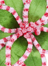 Pick spray features green petals with red and pink edges and faux sugar crystals and red berries in the center.