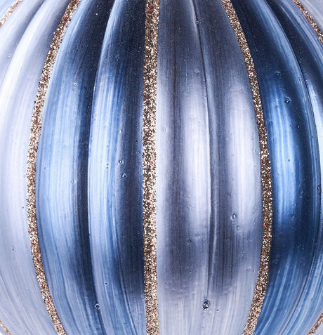 Round ornament with dark blue, light blue and gold glitter vertical stripes.