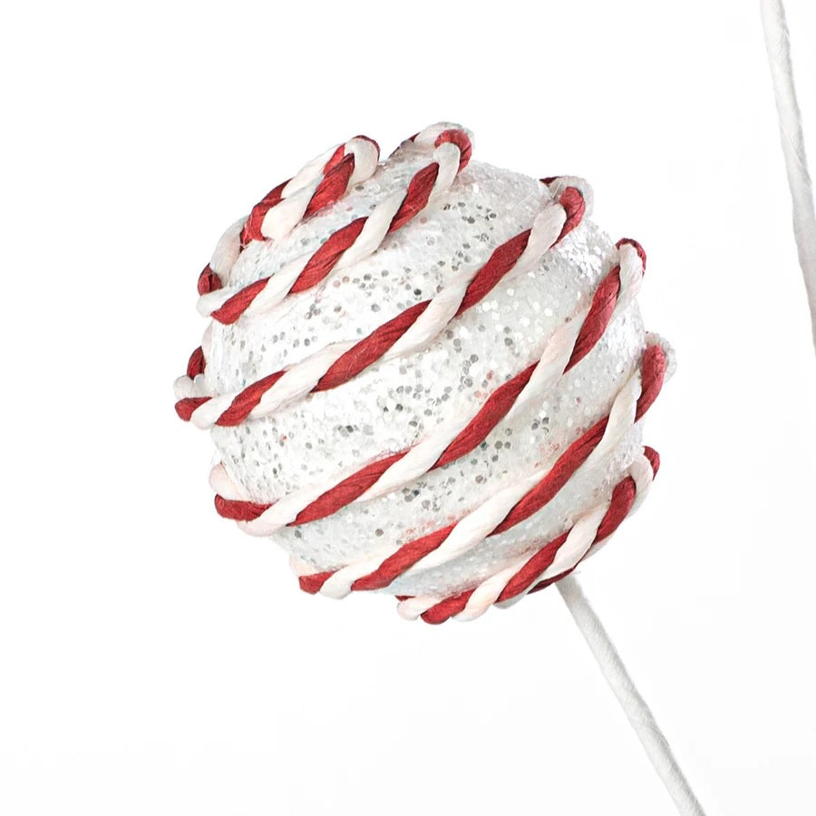 Pick spray with three white glitter balls with red and white stripes.