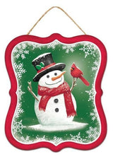 Winter ornament featuring a snowman smiling at a cardinal. This ornament has a red border and a green background. That snowman is wearing a black top hat and a red scarf.