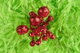 Furry lime green poinsettia-shaped flower pick with red glitter in the center.
