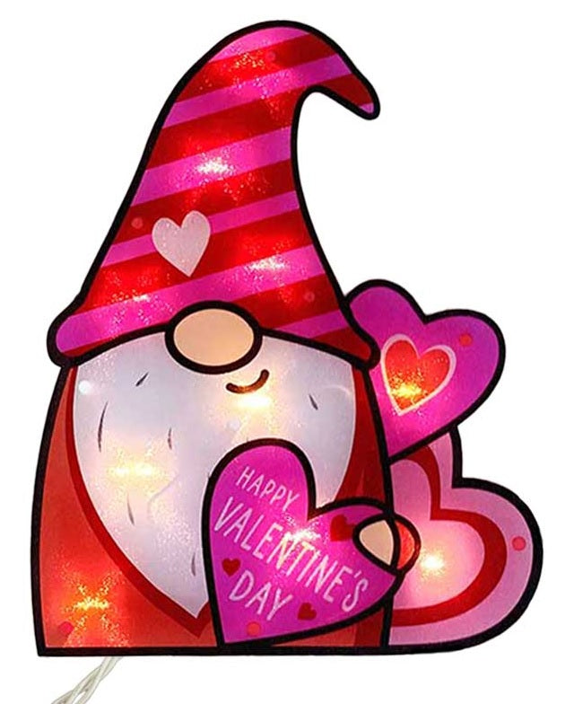 Lighted decoration shaped like a gnome wearing a tall red and pink striped hat. He's holding a heart that reads "HAPPY VALENTINE'S DAY!"