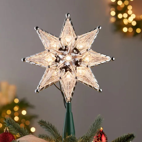 Clear tree topper star made up of three stars combined into one. Green, plastic base.
