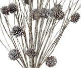 Decorative pick spray designed to look like it's made out snow-covered twigs and pine cones.