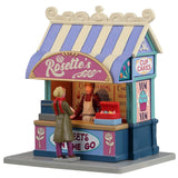 Resin village accent for a Lemax display. Designed to look like a cupcake vendor booth. It's run by Rosette and it's sweets to go. The colors of the booth are light purple, tan, pink, light blue and dark blue.