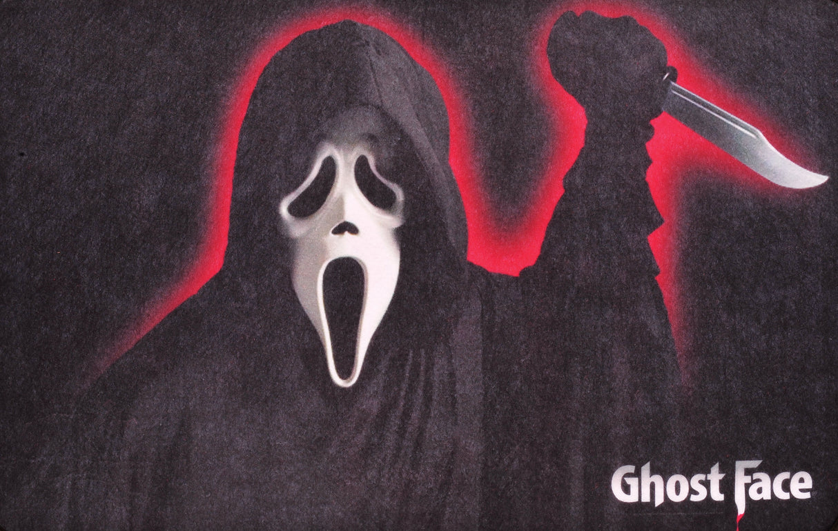 Rug for Halloween. There are two options. One is black with Ghost Face holding a knife. The other option is red and orange and reads "Halloween: A Rob Zombie Film." It has Michael Myers holding a knife in front of a home.