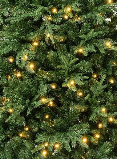 Artificial tree pre-lit with warm white lights.