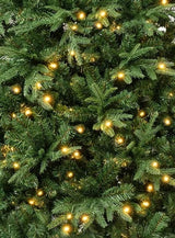 Artificial tree pre-lit with warm white lights.
