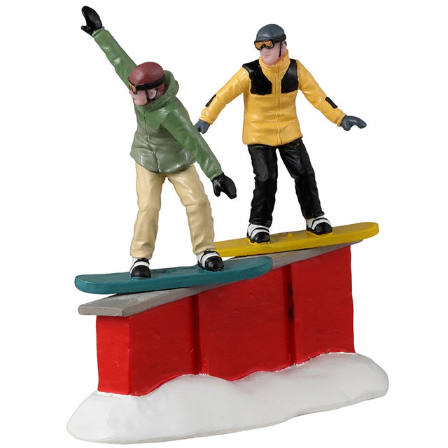 Resin figurine for a Lemax display. Designed to look like two people snowboarding down a ramp.