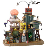 Resin building for a Lemax display. Designed to look like a really weird meat packing plant. There are crows flying above. There's a large statue of a brain going into a meat grinder on the roof. There are monsters working.