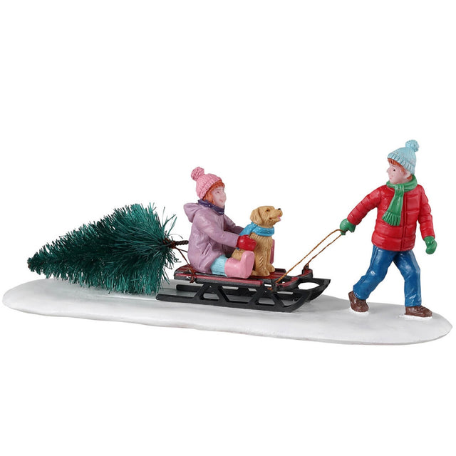 Resin village accent for a Lemax display. Designed to look like a young boy dragging a sled with a young girl and a little dog on it. The sled is also dragging a tree.