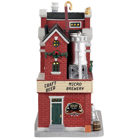 Porcelain lighted building for a Lemax display. Designed to look like a large, brick brewery. There are silver barrels of beer on the roof, decorated wreaths and garland and stools outside for patrons to enjoy drinking on the sidewalk by the bar.
