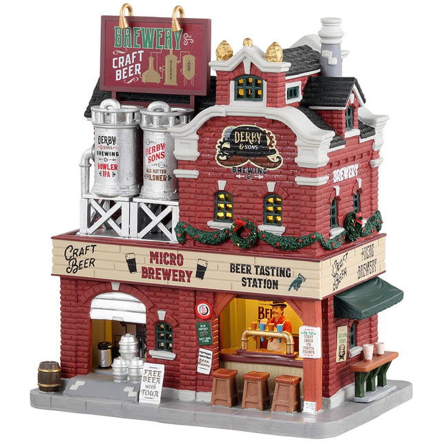 Porcelain lighted building for a Lemax display. Designed to look like a large, brick brewery. There are silver barrels of beer on the roof, decorated wreaths and garland and stools outside for patrons to enjoy drinking on the sidewalk by the bar.