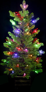 Artificial tree pre-lit with Starry lights. Tree is decorated with red berries and is in a pot.