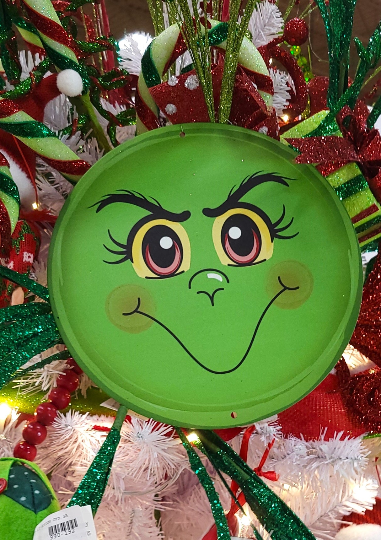 Round decoration designed to look like Grinch's green face.