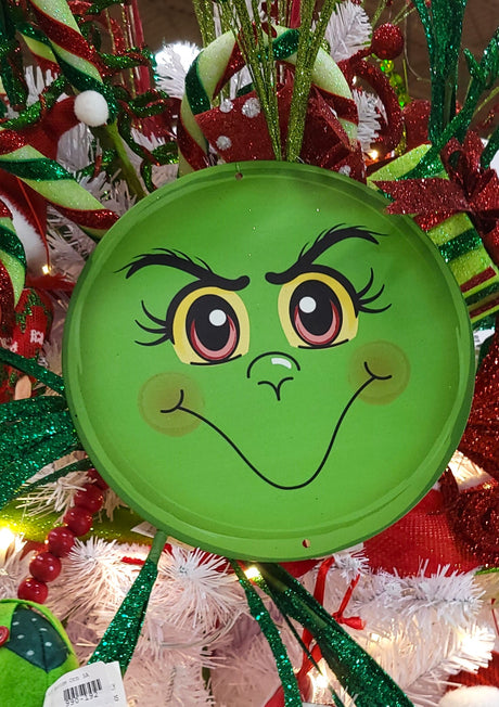 Round decoration designed to look like Grinch's green face.