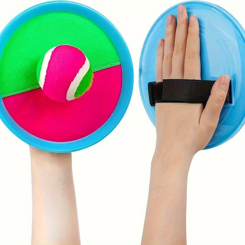 This image shows the Velcro paddles and the soft ball stuck to one of the paddles. This picture shows how the paddle gets Velcro-ed to a hand.