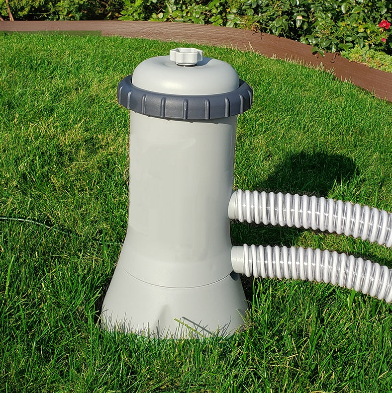 This is a lifestyle image showing a pool filter with the hose coming out of it.