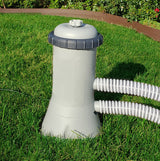 This is a lifestyle image showing a pool filter with the hose coming out of it.