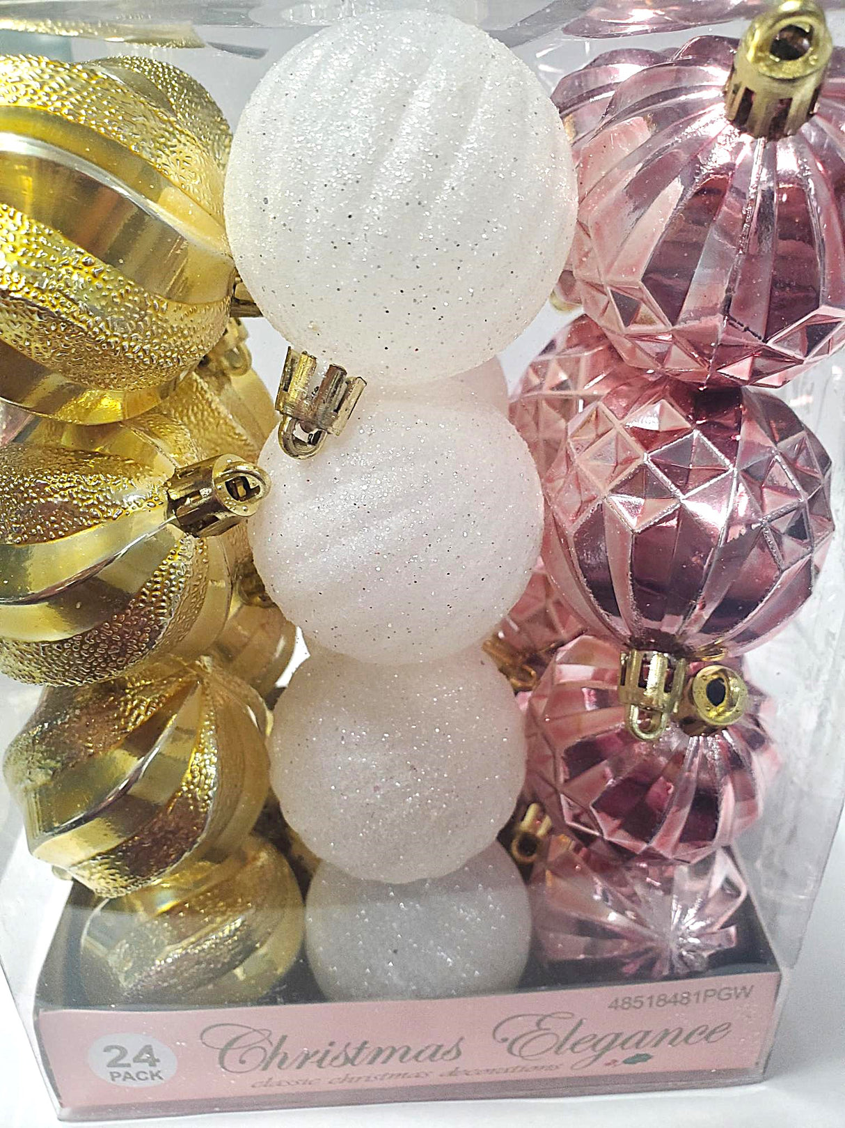 Set of 24 ornaments with different textures. 8 of the ornaments are a shiny gold color. 8 of the ornaments are a glittered white color. 8 of the ornaments are a shiny rose gold color.