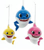 Baby Shark themed ornaments. Baby Shark is yellow. Mommy Shark is pink. Daddy Shark is blue.