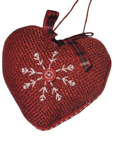 Heart-shaped Christmas ornament. One ornament is red with a white snowflake in the center. One ornament is white with a red snowflake in the center.