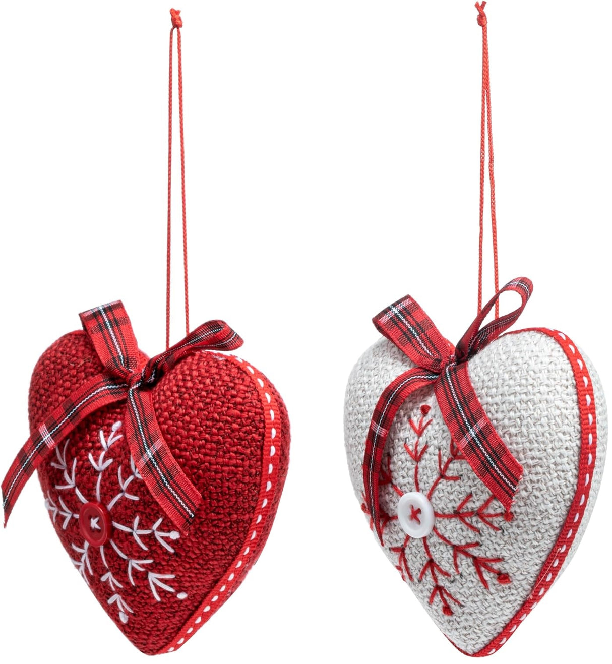 Heart-shaped Christmas ornament. One ornament is red with a white snowflake in the center. One ornament is white with a red snowflake in the center.