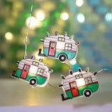 This is a lifestyle image showing the camper lights. The campers are white, red and green. They have red doors, two windows and multi-colored "lights" on the roof.