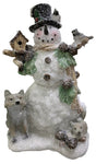 Snowman figurine covered in glitter. He's wearing a top hat and holding a birdhouse. There's a fox and a squirrel at the base and birds on top. There are pine cones and pine needles.