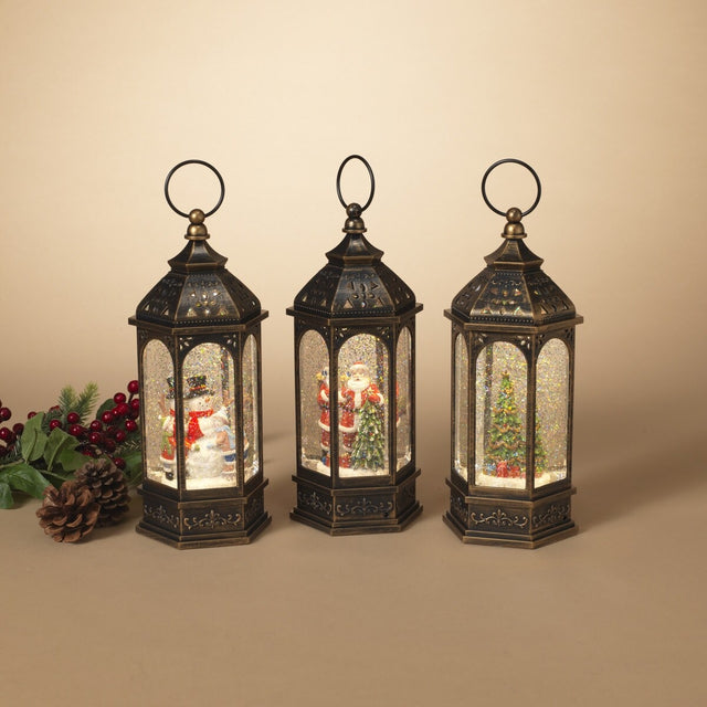 Bronze lanterns with snow globe inside. One lantern features a snowman with two kids. One lantern features Santa with a tree. One lantern features a decorated tree with presents underneath. There's swirling glitter and lights inside.
