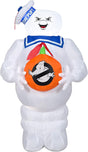 Halloween inflatable shaped like the Stay Puft Marshmallow Man from the movie Ghostbusters. He's holding a pumpkin with the Ghostbusters logo on it.