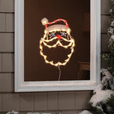This is a lifestyle image showing the Santa head silhouette hanging in a window.
