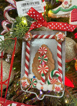 Ornaments designed to look like cookies in silver cut outs or on trays.
