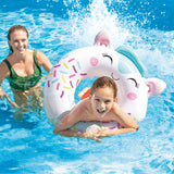 This is a lifestyle image showing a young boy swimming using the horse inner tube while his mom looks on.