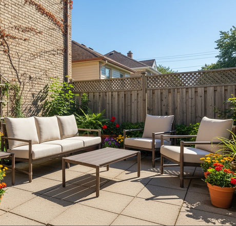 This is a lifestyle image showing this patio furniture set on a stone patio on the side of a brick house. There are potted plants and vines growing on the house.