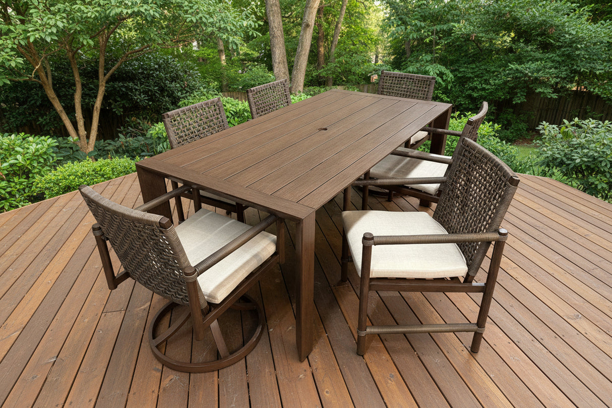 This is a lifestyle image showing what this patio furniture set looks like. The table and chairs are brown and the chair cushions are a light tan color.