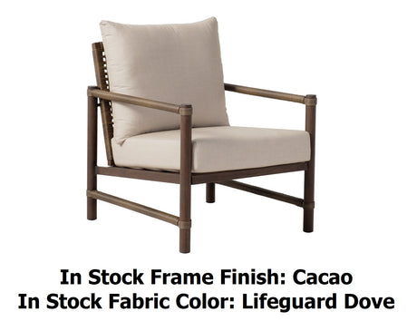 This image shows this lounge chair on a white background. The image also reads "In Stock Frame Finish: Cacao. In Stock Fabric Color: Lifeguard Dove."