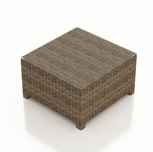 This image shows the square end table on a white background. The frame is a brown wicker. The tabletop is glass.