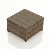 This image shows the square end table on a white background. The frame is a brown wicker. The tabletop is glass.
