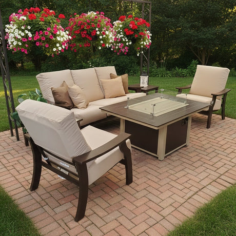 This is a lifestyle image showing this patio furniture set on a brick patio in a grassy, Midwestern backyard. There are hanging pots of flowers.