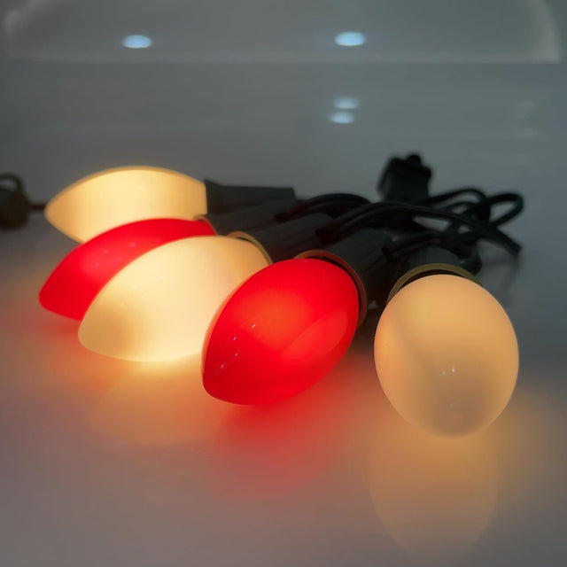 This is a lifestyle image showing these red and white opaque LED lights on a white counter.