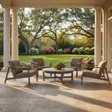 This is a lifestyle image showing this outdoor patio furniture set on a stone patio in a nice backyard.