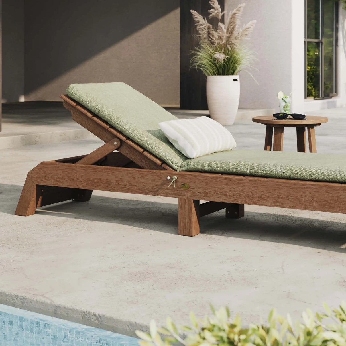 This is the same image as the one before except this chaise lounge chair has a light green colored seat cushion on it.