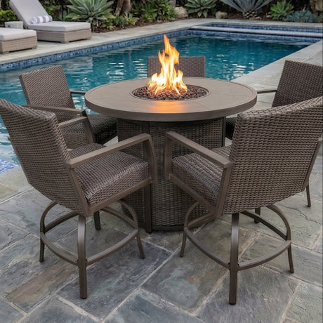 This is a lifestyle image showing these five wicker barstools around a wicker fire pit table on a stone patio next to an inground pool.